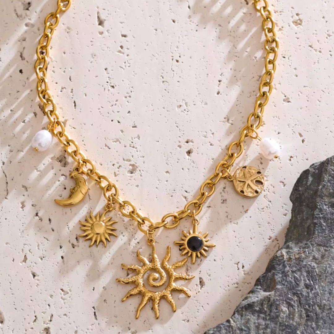 Golden celestial necklace with sun, moon, and starfish charms in waterproof 18K gold plated stainless steel