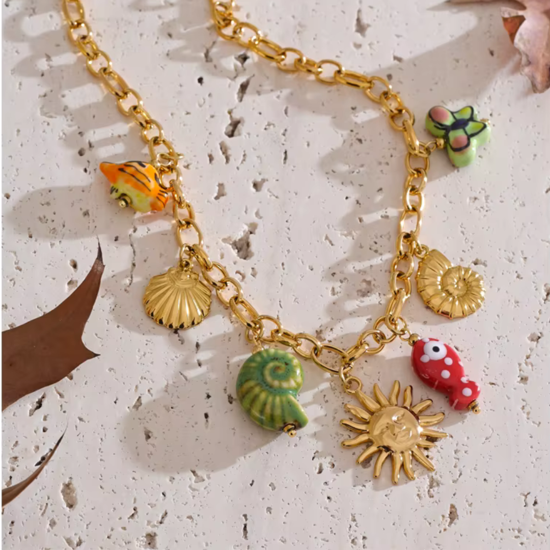 Handmade ocean-inspired necklace with ceramic charms and waterproof PVD gold finish
