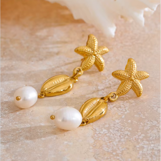 Drop earrings with pearl, shell, and starfish charms in stainless steel.